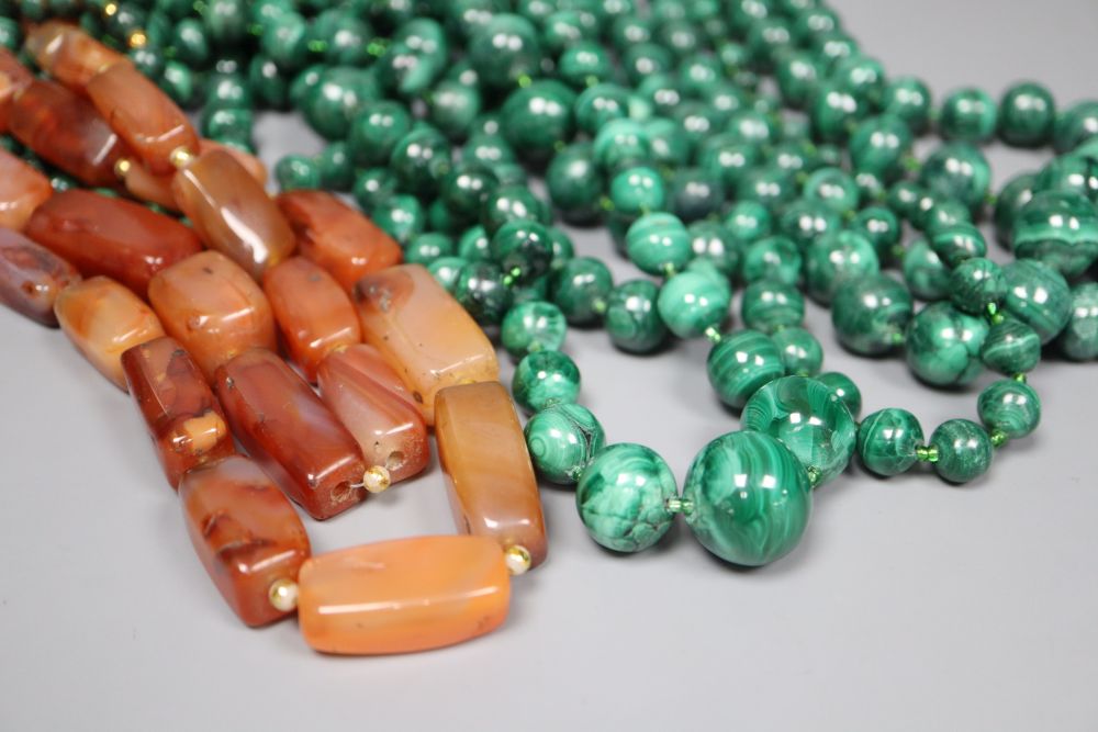 Nine assorted single strand malachite bead necklaces, one with gilt metal spacers and two agate pebble necklaces, largest 64cm.